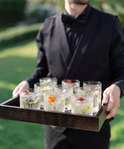 bartender serving drinks and signature cocktail with bespoke customized decor and garnish